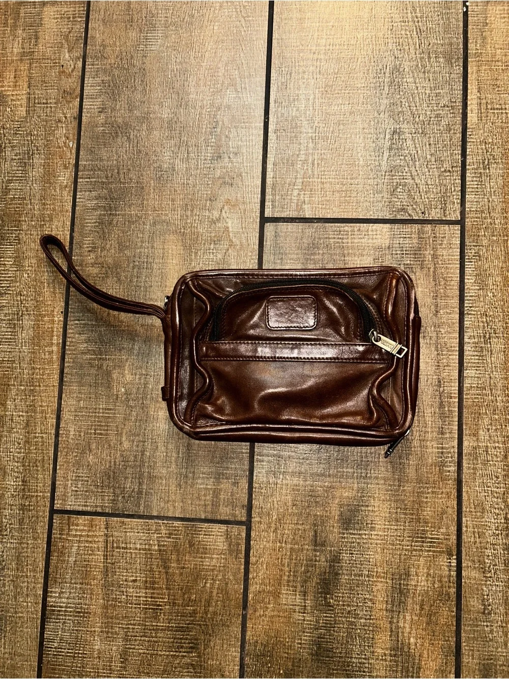 TUMI brown leather travel bag